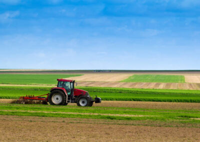 Farm tractor plowing the land istockphoto 154952202 612x612 1